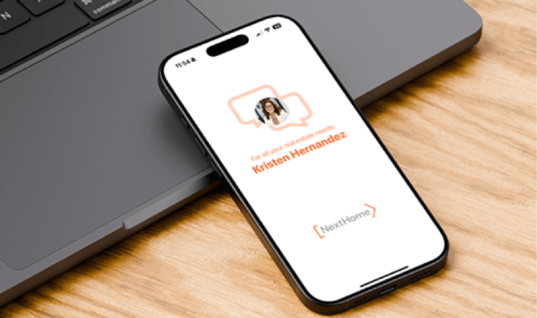 A smartphone leaning on the palm rest of a laptop, displaying the cover screen for the NextConnect mobile app